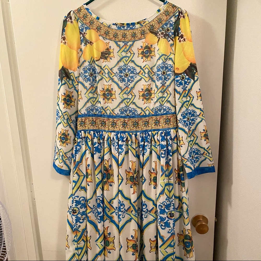 Beautiful lined yellow and blue printed long sleeve dress. Fits size 8 $25